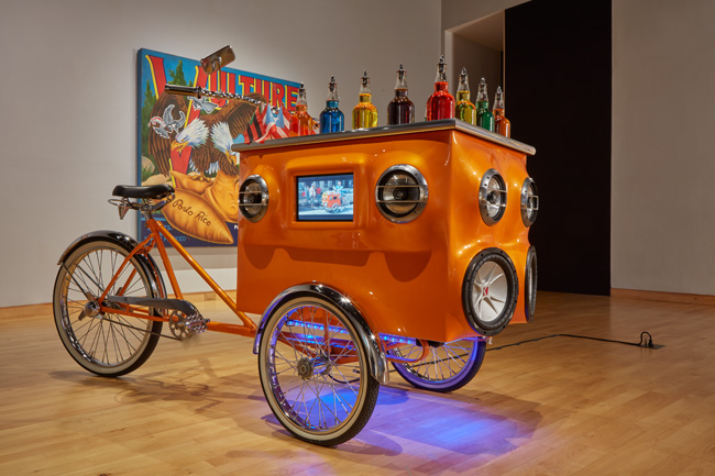Miguel Luciano, Pimp My Piragua, 2008-2009; Vulture Brand Yams, 2017. Courtesy of the artist. Installation view of Constant Storm exhibition at USF Contemporary Art Museum. Photo: Will Lytch.